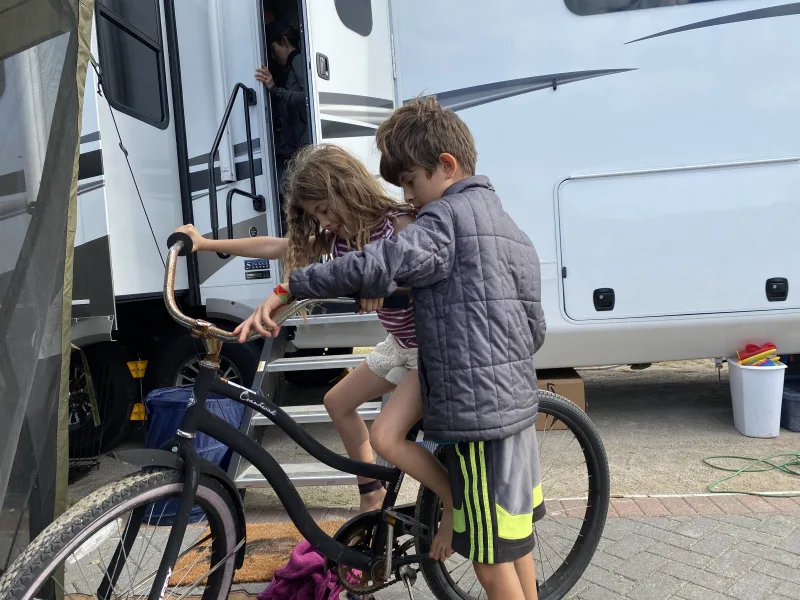 Our son helping our daughter ride her bike for he first time
